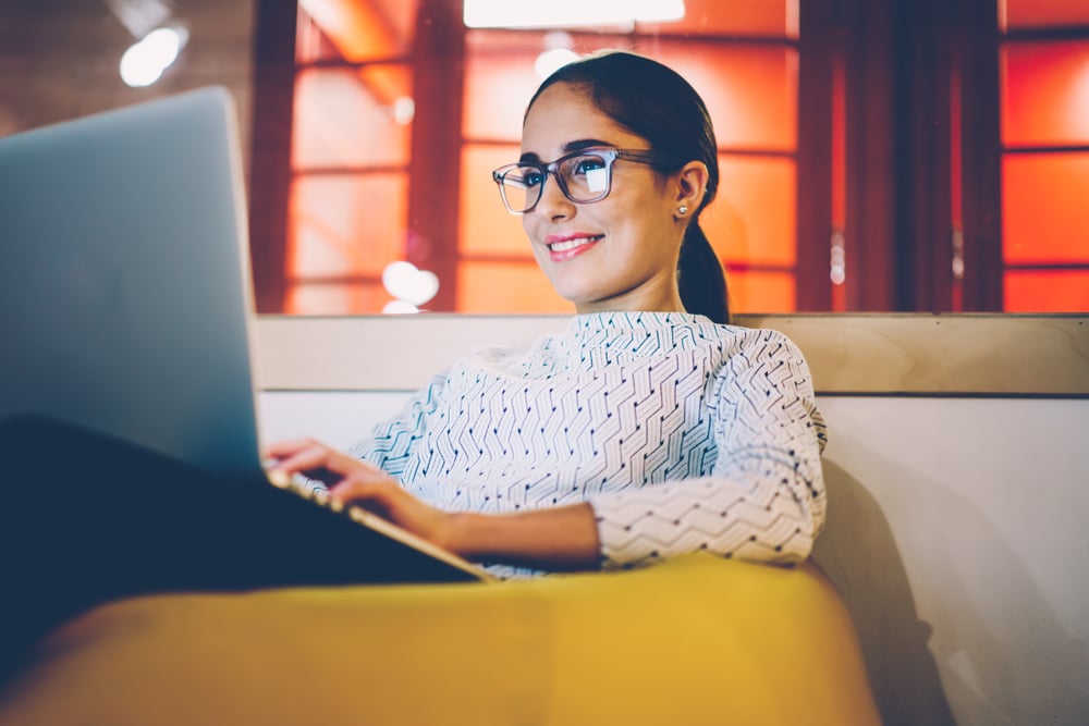A girl smiles as she enjoys content online.